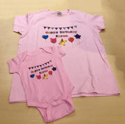 Pink adult T-shirt and baby onesie with bunting, balloons, and 'Happy Birthday Karen' design, example of screen printing t shirts for matching sets. At Wow! Custom Tees
