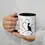 Thumbnail: Hand holding a white ceramic mug with black handle and interior, showing a minimalist black cat design with hearts.