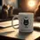 Thumbnail: Marked by Magic mug on wood table, moonlight and two cats blurred in background.