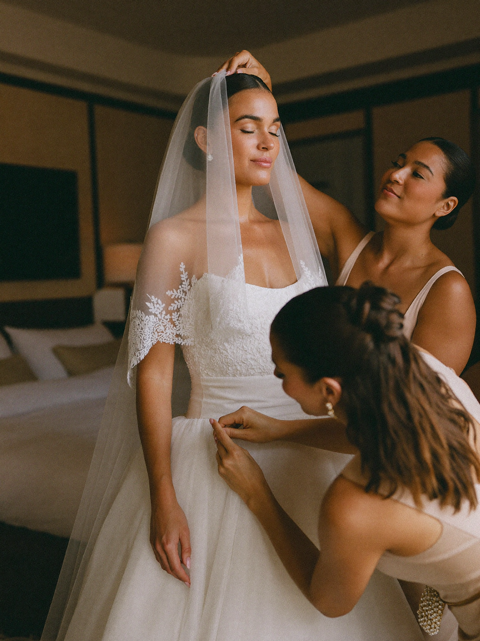 14_two-bridesmaids-fixing-veil.png
