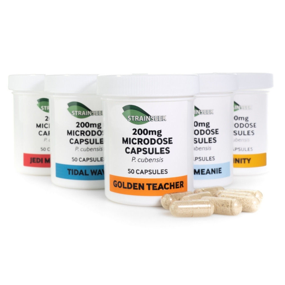 A lineup of six white 50-count jars of StrainSeek 200mg P. cubensis microdosing capsules with loose capsules in foreground