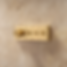 Kohler Anthem Thermostatic Valve Trim in Brass on limestone tile wall.