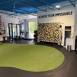 Chardon Performance Therapy clinic with turf and Achieve Your Impossible wall