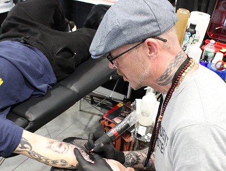 Chad Wheeler tattooing an arm at High Street Tattoo