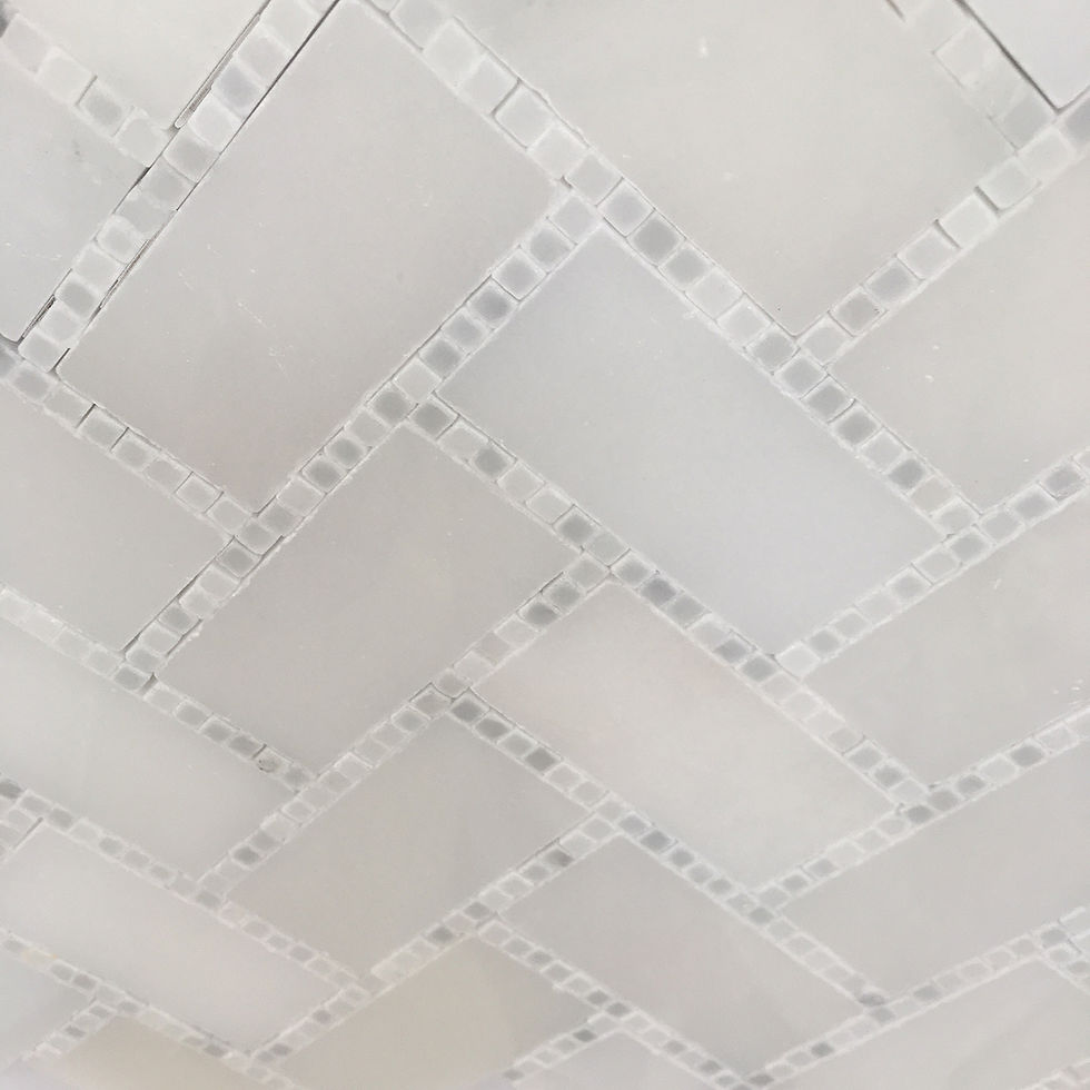 Sometimes stone flooring makes all the difference in the world, like this herring bone glacier and carrara micro dots