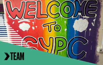 Mural with rainbow background reads welcome to SYPC.