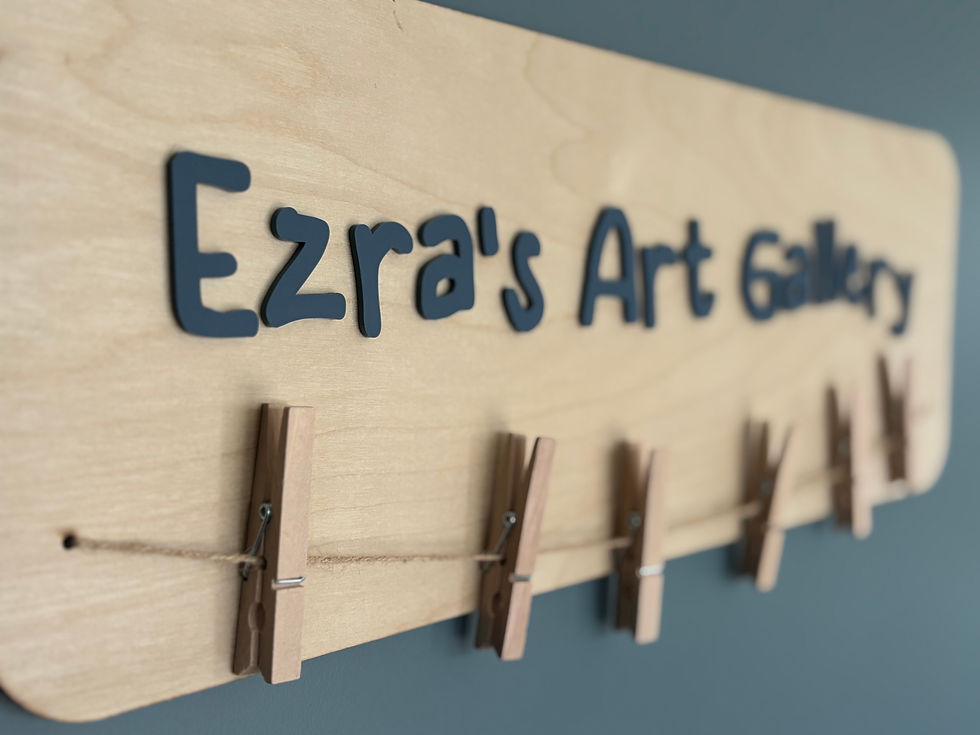 Thumbnail: Wooden board for wall hanging which states 'Ezra's Art Gallery' to display art work. Work hung via jute rope and wooden pegs