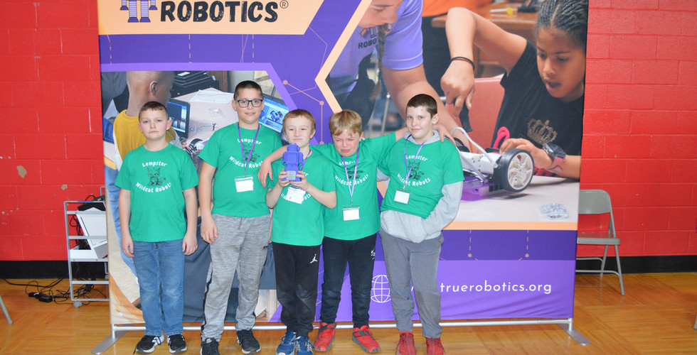 Winning teams proudly hold their trophies, smiling and celebrating their achievements at the robotic
