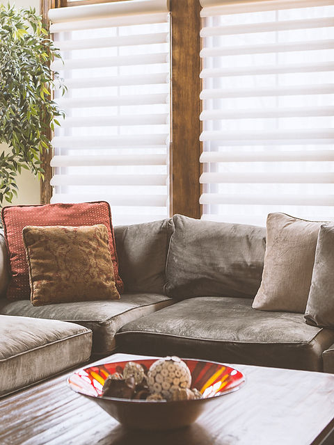 couch with blinds behind