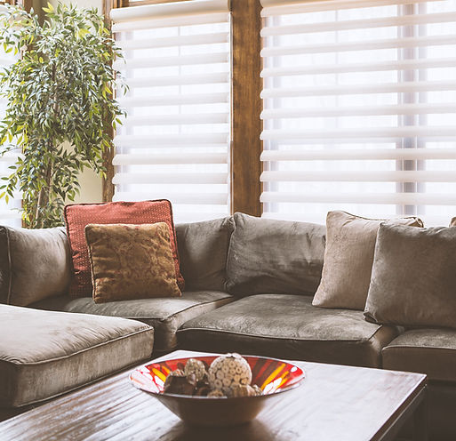couch with blinds behind