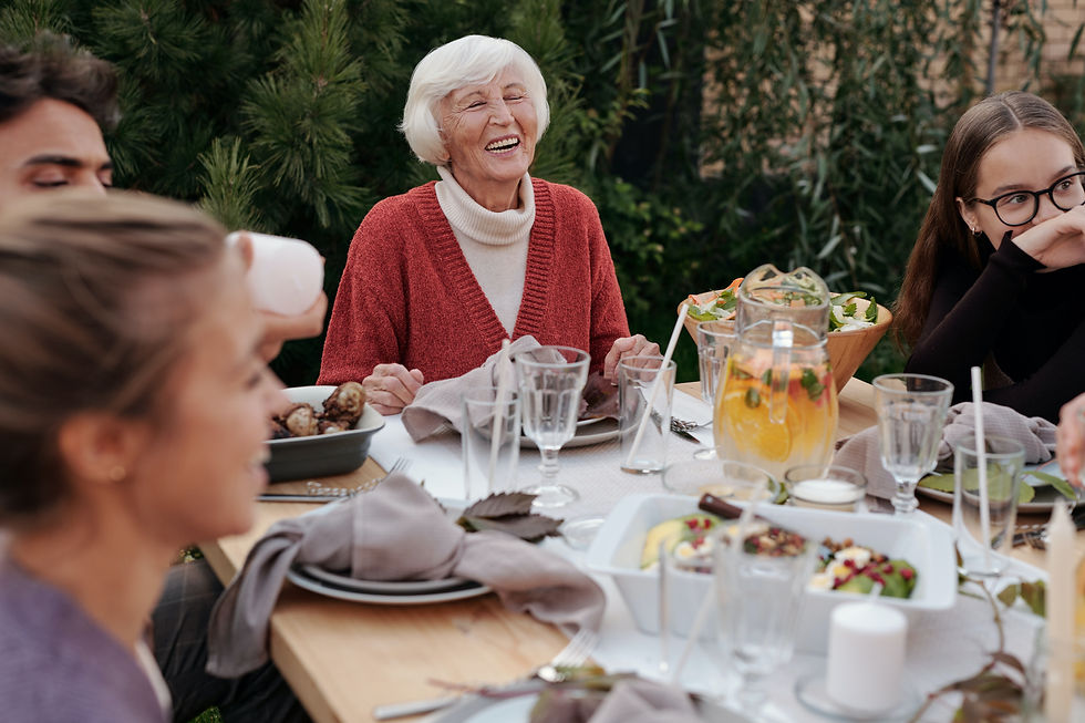 Family sits around a table for dinner