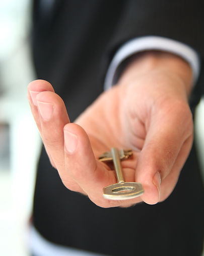 Close up of trusted man handing you the key to success