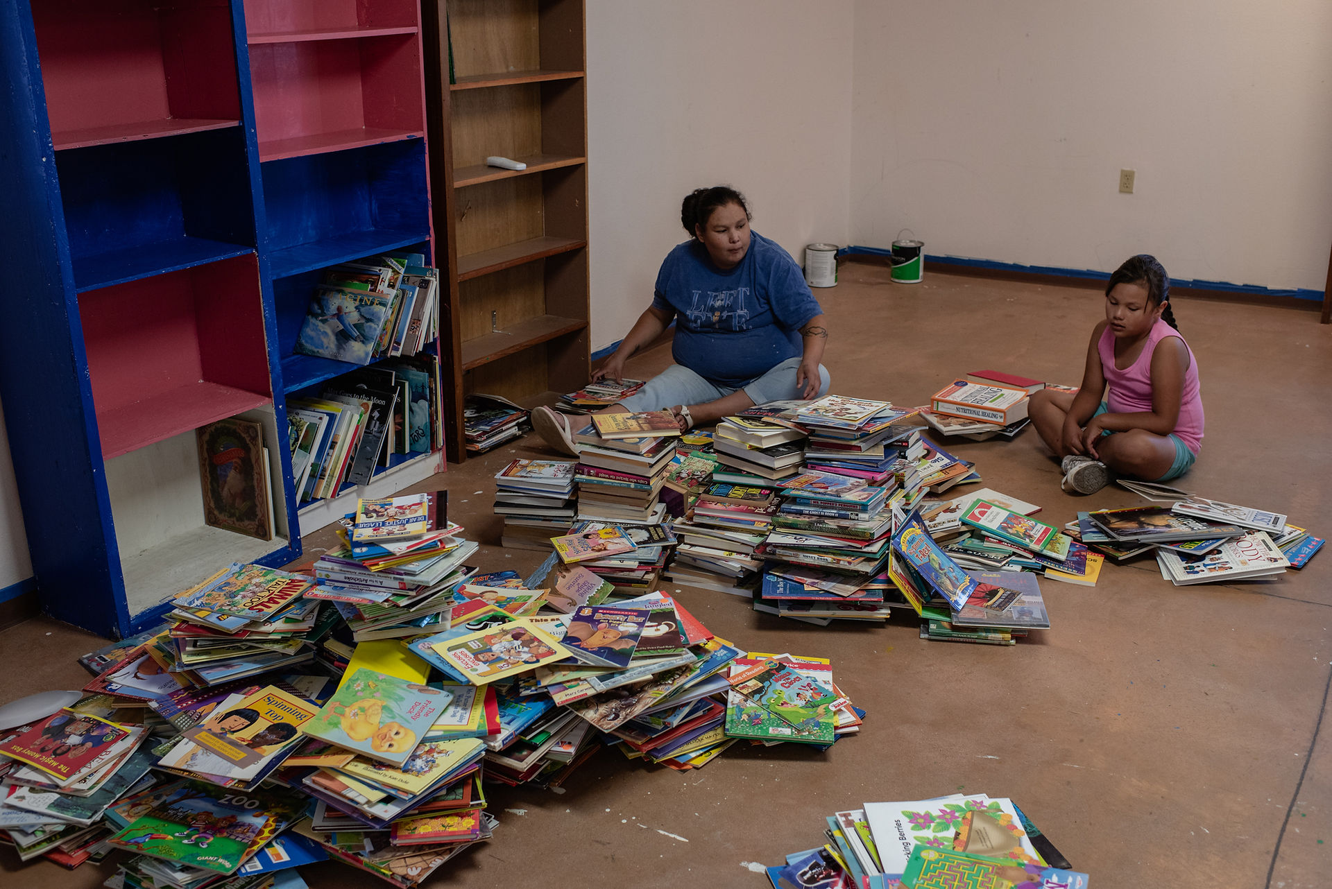 Kids reorganizing bookshelves