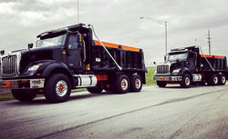 Two ADC Paving Trucks