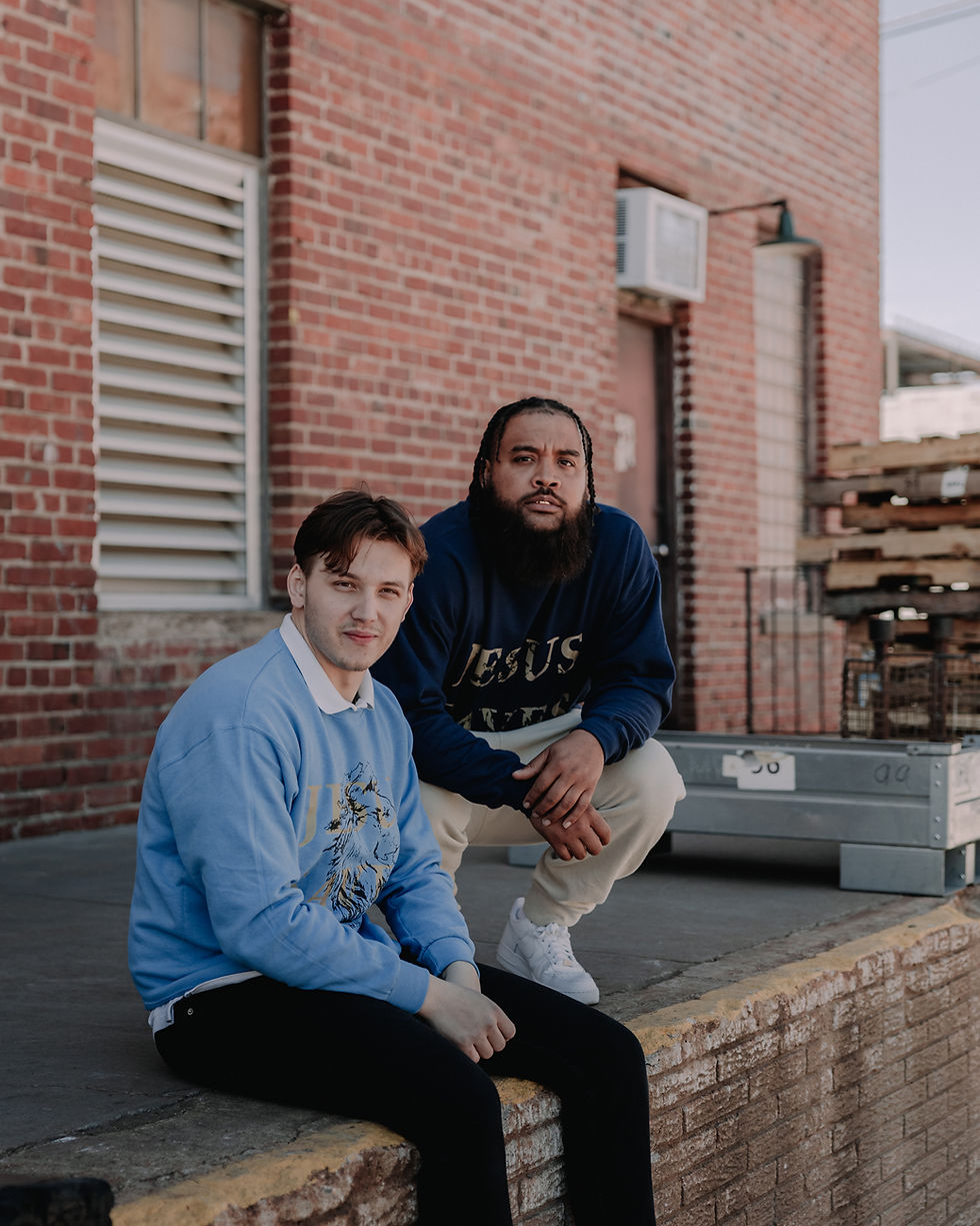 Thumbnail: Light & Navy Blue cotton & polyester crewneck that says "Jesus Saves" in tan letters, with a black lion behind the words.