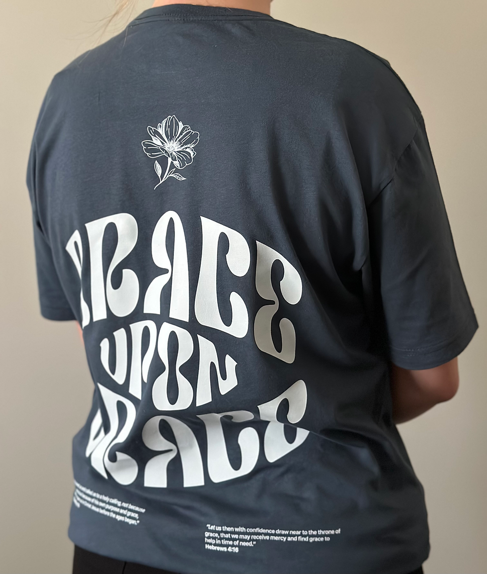 Thumbnail: Blue cotton t-shirt with large, graphic letters that say Grace Upon Grace down the back, with two small verses on the bottom.