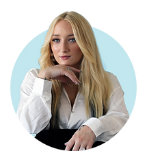 Blonde woman in white shirt looking at camera