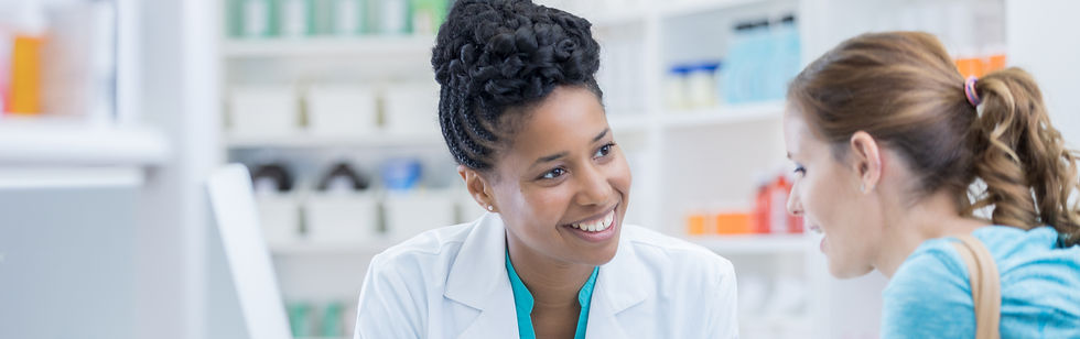 a smiling pharmacist speaking with a customer