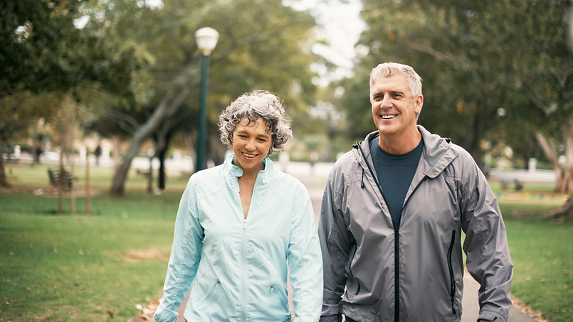 Elderly Couple Walking in Park