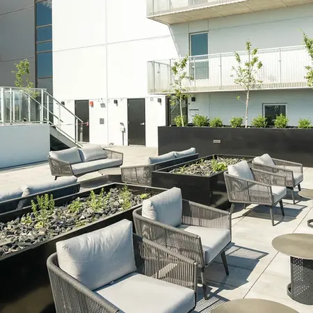 Outdoor lounge area surrounded by Urban Pot planters, WALT terrace in Dorval, QC