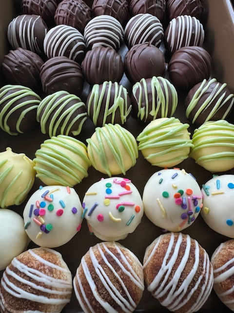 Top-down view of assorted Hiyas Ballz lined up in rows, showcasing multiple Delta-9 edible flavors in one visual spread