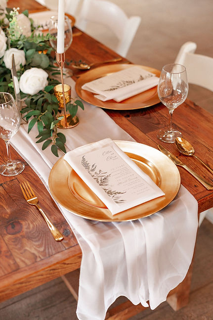 Elegant wedding table setting with gold charger plates
