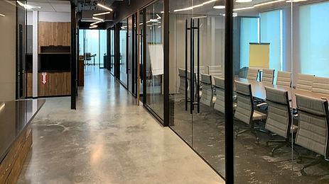 Reception Area to internal corridor with Kitchen/Break Room and Offices.