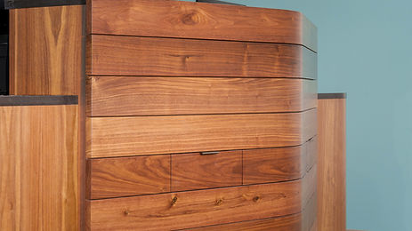 New custom wood veneer reception desk with bent wood slats.