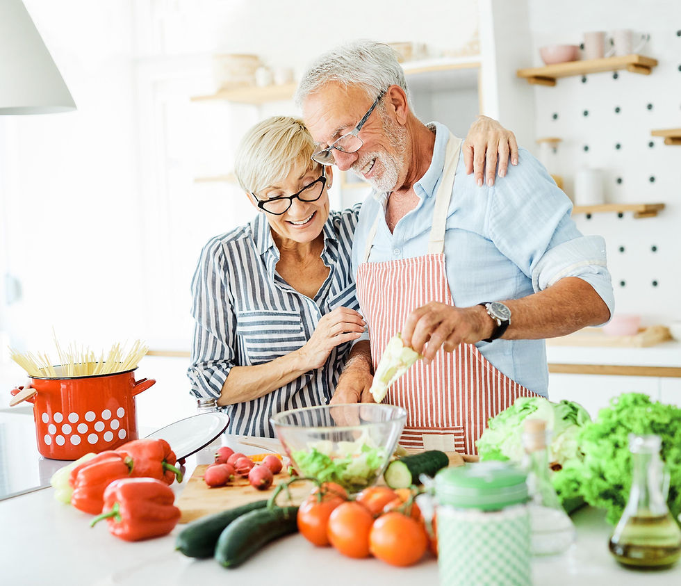 Senior happy couple cooking healthy meal in a kitchen