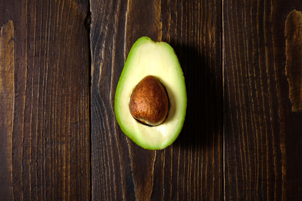Half an avocado on a dark wooden background
