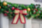 Christmas Garland with a large red and gold bow