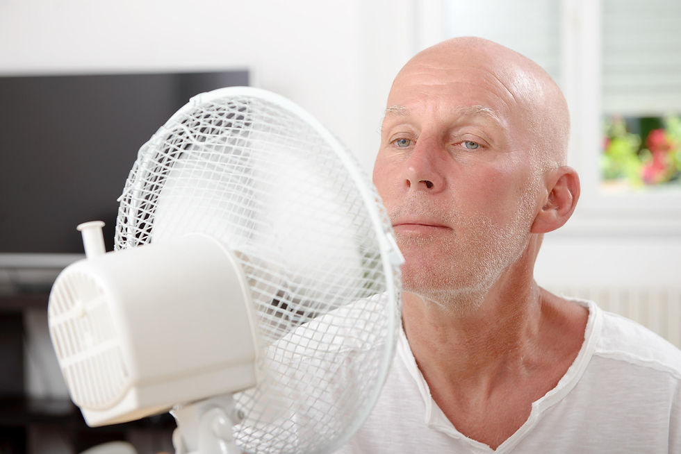 Mature man sitting behind a fan