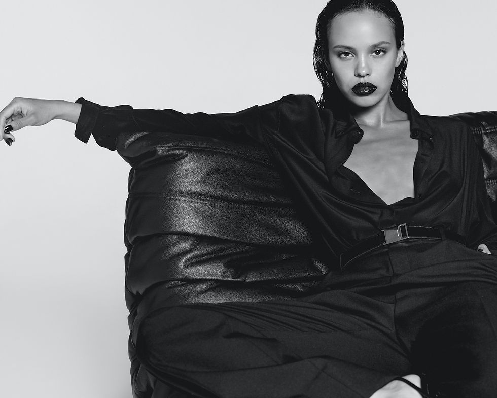 Alisha Boe on a sofa pictured in black and white for the new Black Opium campaign