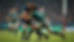 Eye-level view of a rugby player tackling with shoulder impact