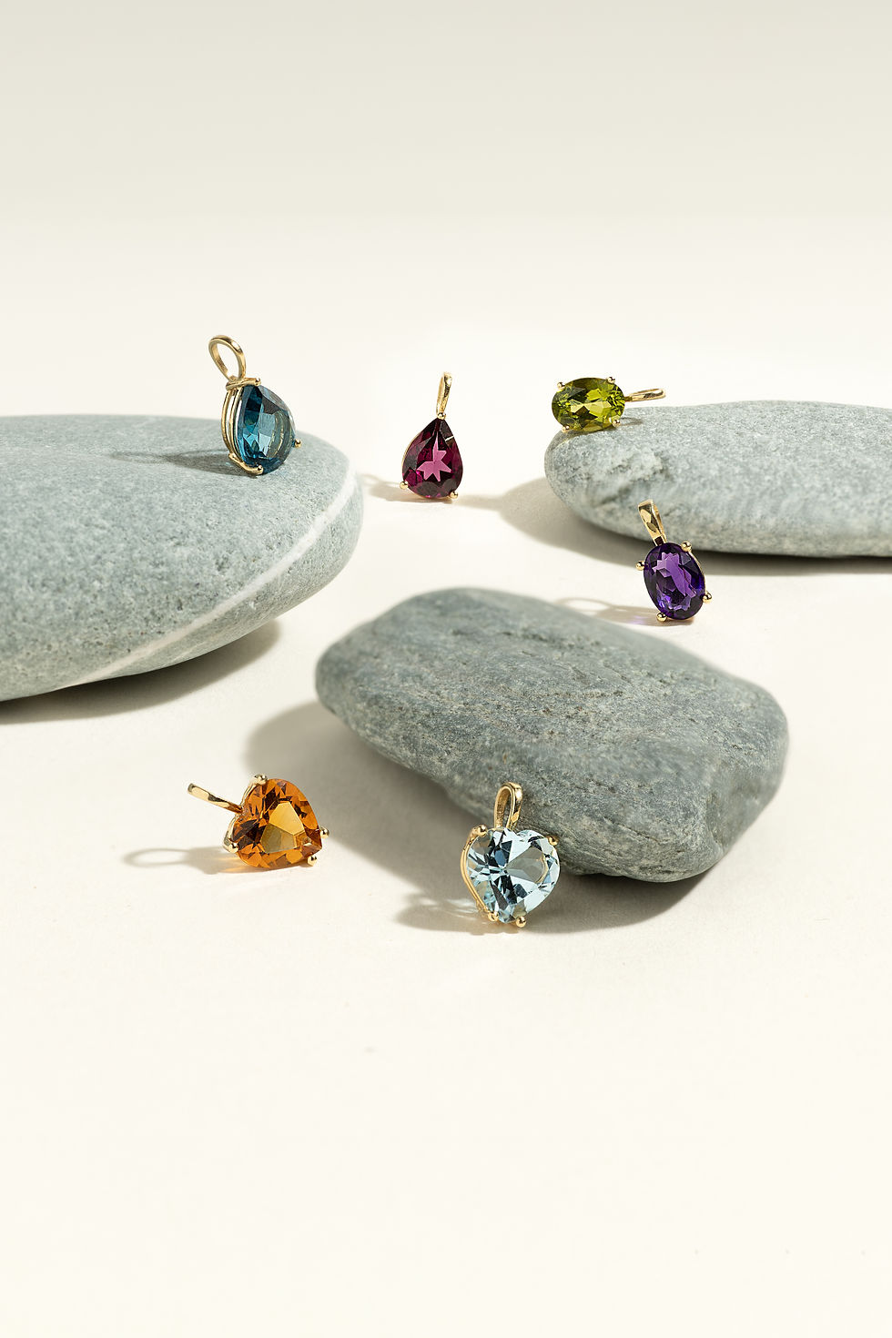 Miniatura: Gemstone pendants on rocks. OCTOBER pendant - Blue Tourmaline - LUMIÈRE. Minimalist jewelry display on white.