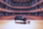 a grand piano in a concert hall