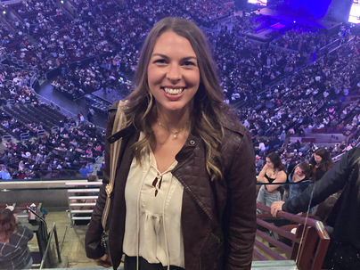 girl standing in front of concert venue