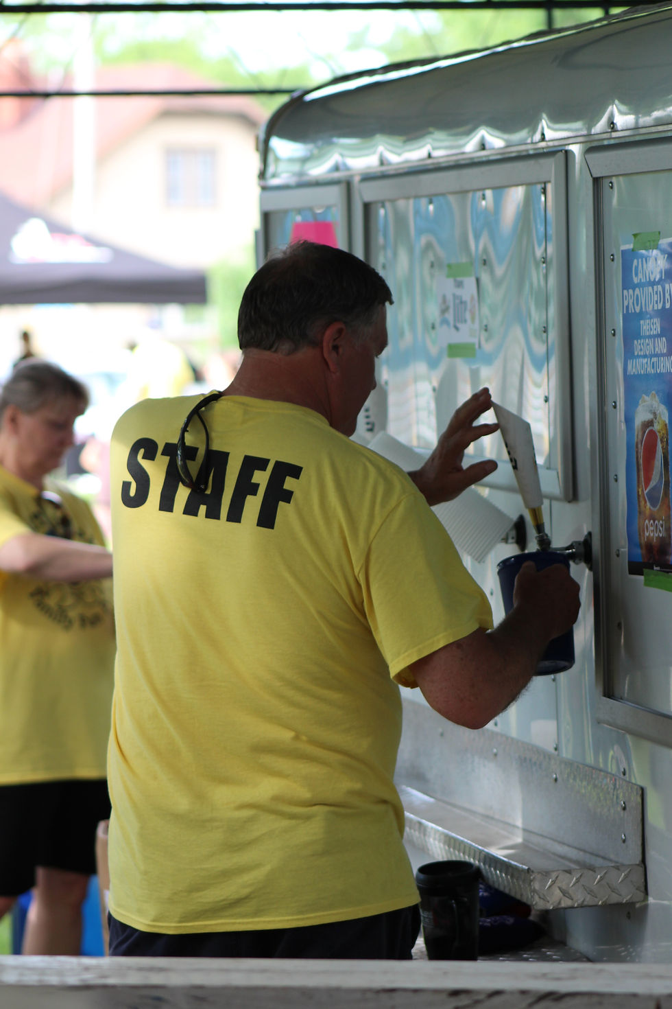 Family Fun Fest staff serving beverages at the festival grounds