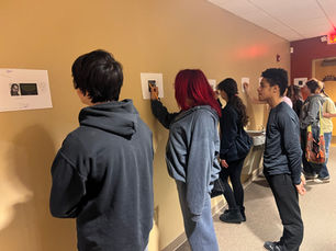 Teens participate in the conference session: “What is my responsibility” by writing notes on various photos hung around the space