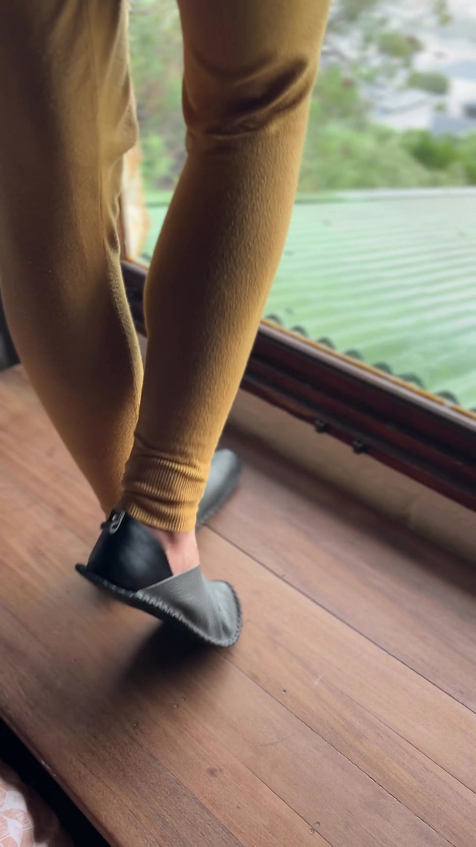 Thumbnail: Minimalist black and grey leather barefoot shoe designed for comfort, breathability, and a connected walking experience.
