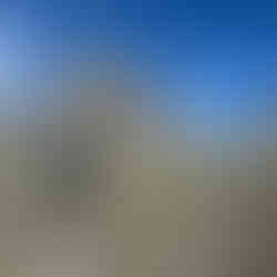 A person walking toward a mountain hut