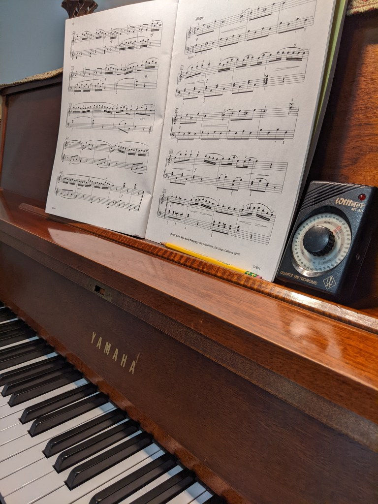 Piano with music and metronome; Piano Practice Tips with Blossom Piano Studio