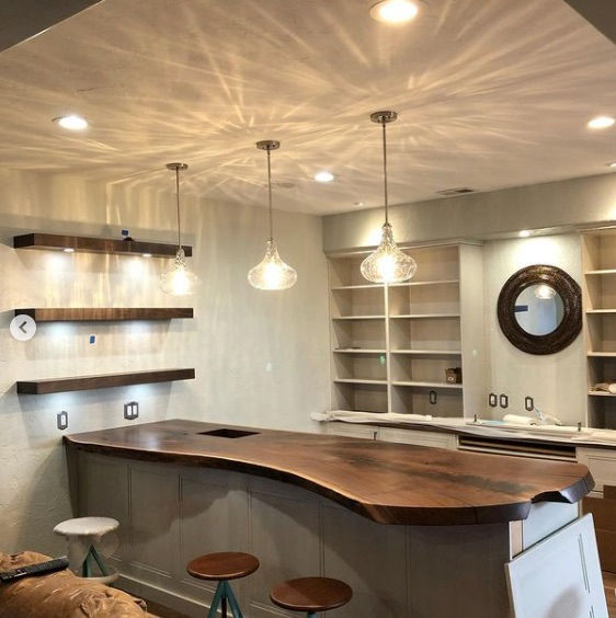 Full walnut slab countertop with live edges shown in kitchen