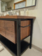 Close up view of steel supports and paper holder on walnut vanity cabinet custom made in Denver Colorado.