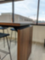 close up of floating wood table top with waterfall on wood and steel conference table in office