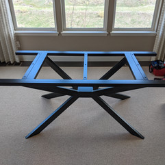 Steel dining table frame with extensions for table leaves.