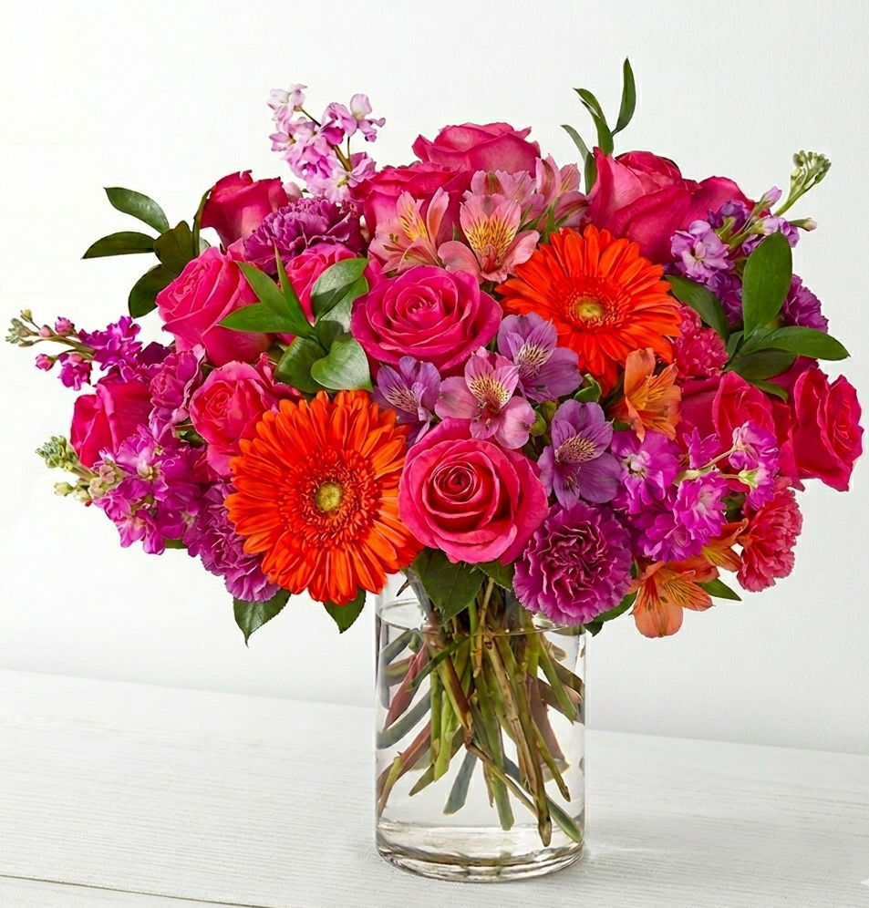 Radiant Joy floral arrangement with orange gerbera daisies and pink roses by Floral Haven YYC Calgary