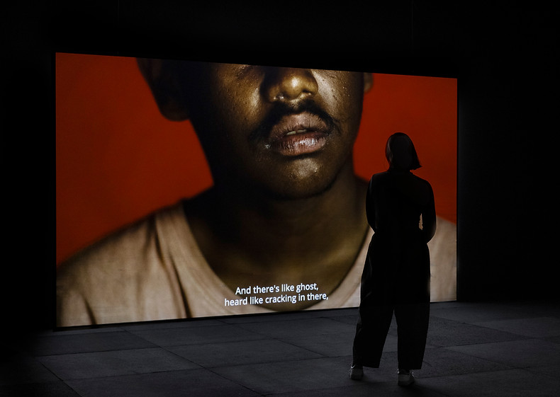 Installation image of Code Black/Riot (2025), 4-channel video installation at Campbeltown Art Centre, 25th Biennale of Sydney, March-June 2026