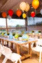 Curated event setup with decorated tables and balloons
