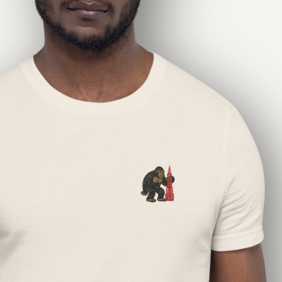 Thumbnail: Pocket King Kong tee with minimal chest embroidery of King Kong holding a red skyscraper